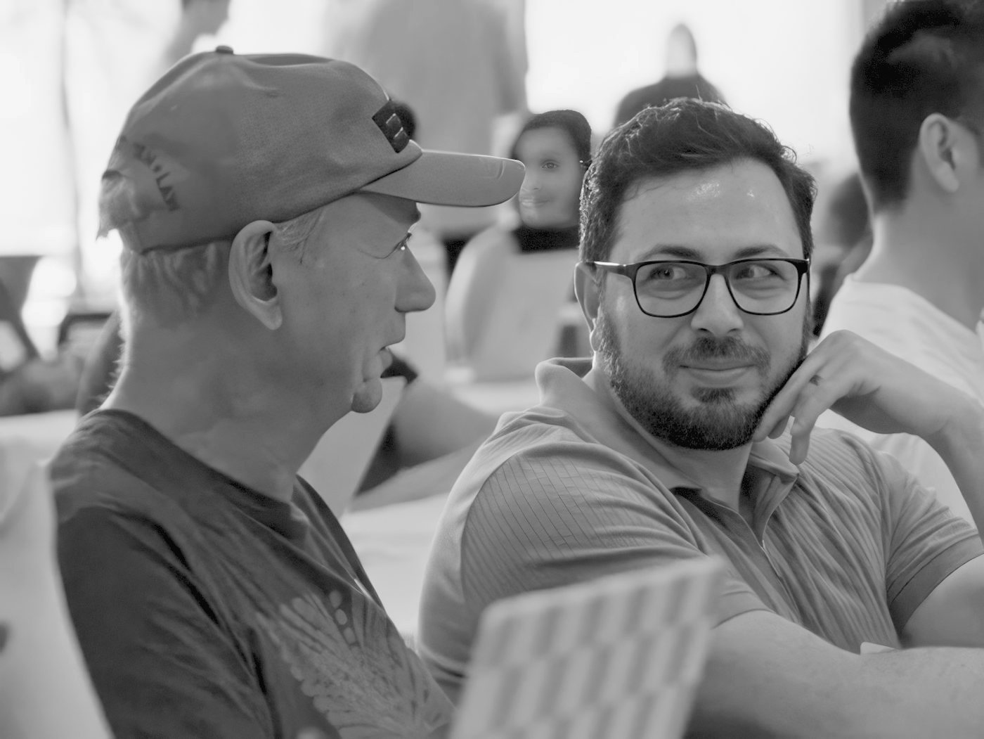 People talking between sessions at a Claude community event.