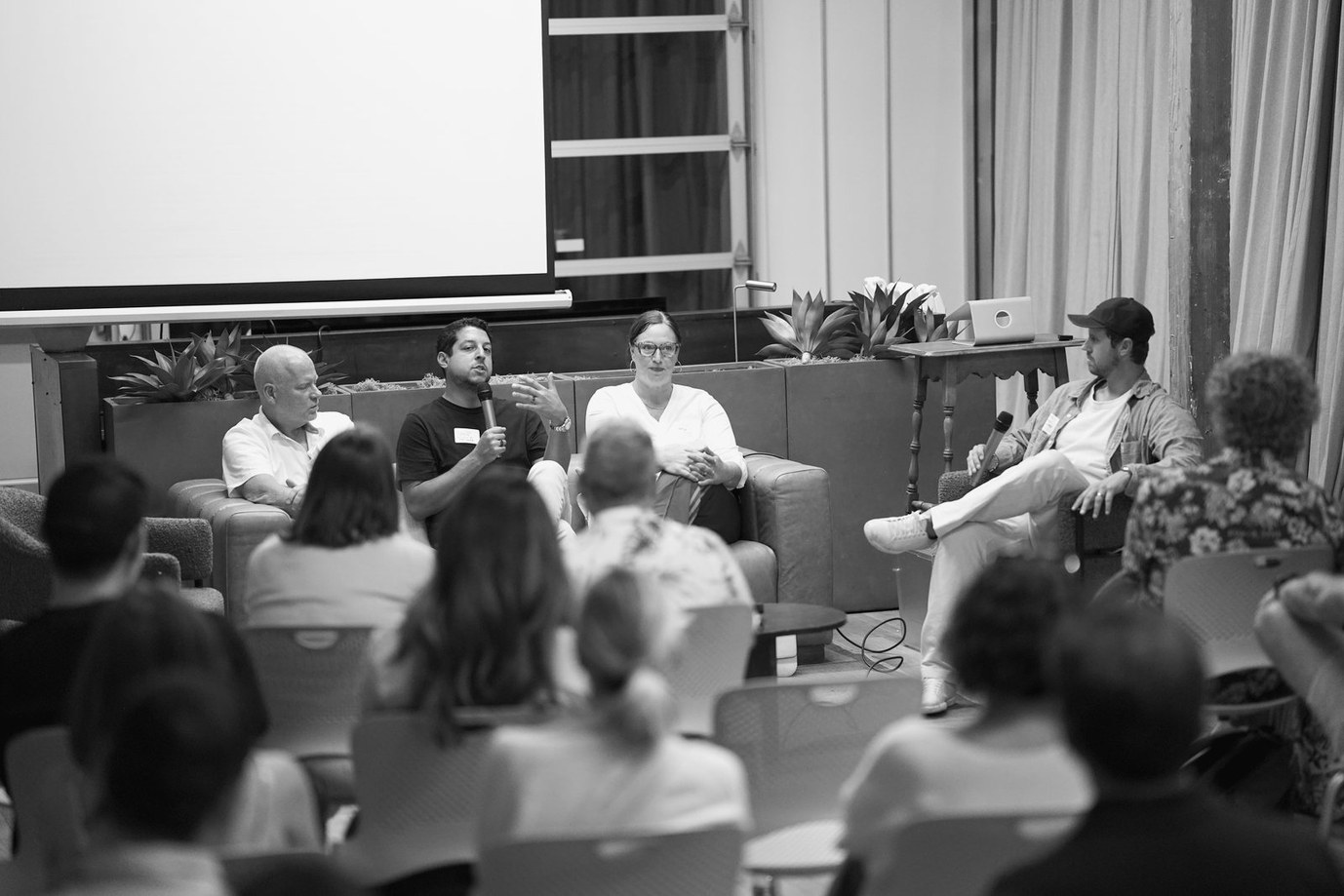A panel on stage at a Claude event in Santa Barbara, audience in the foreground.