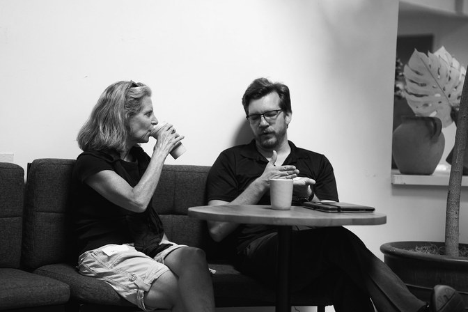 Two people in conversation at a Claude event